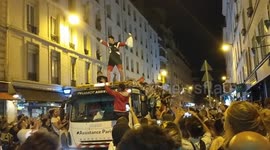 French football fans dancing on a Peugeot recovery truck dance through streets of Paris after semi final World Cup victory singing On Est En Finale