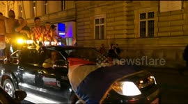 Football fans climb car roof on streets of Croatian capital