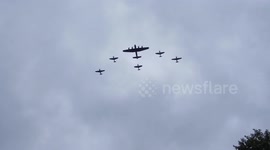 !00 years of the RAF air show across London. Lancaster boomer flanked all round by different ww2 aircraft, flying in formation over Trafalgar Square and on down Pall Mall to Buckingham Palace by Jim Connor