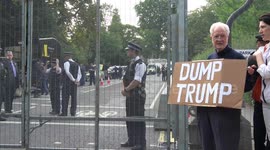 Protester holds ‘Dump Trump’ sign at president’s residence in London
