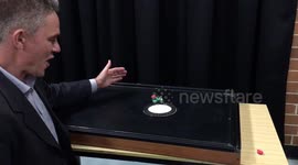 Science Teacher uses mini wind-up train and air table to teach simple science principle.