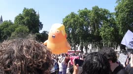 Trump blimp in Westminster square across the road from the house of commons crowd cheering thousands of people taking selfies and photos by Jim Connor