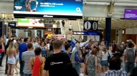 French fans chant through London's Liverpool Street station after victory