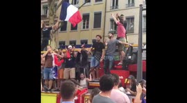 French fans hop on moving firetruck during World Cup celebrations in Lyon