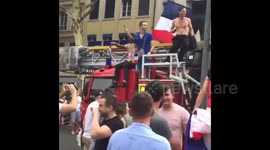 French fans hop on moving firetruck during World Cup celebrations in Lyon