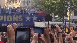 French fans go wild as team bus passes by during World Cup victory parade
