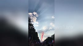 French jets greet fans with red, white and blue smoke during World Cup victory parade