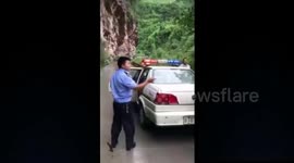 Huge boulder lands on moving car in southern China