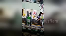 Girl jams head between escalator handrail and wall
