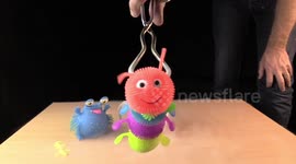 Multi-coloured squishy toy caterpillar frozen in Liquid Nitrogen and smashed with hammer
