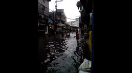 Kids play in the water during Typhoon Henry floods in Philippines