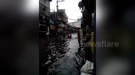 Kids play in the water during Typhoon Henry floods in Philippines