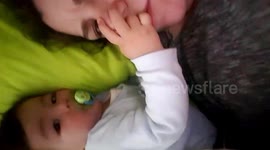 baby boy playing in bed