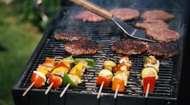 BBQ Burgers being flipped in slow motion