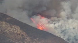 Wildfire season: Flames burn up brush and mountain side