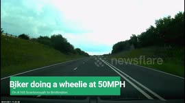 Biker pulling a wheelie at 50mph. Overtakeing on the outside of a crawler lane on the back wheel.