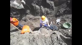 A volunteer from Antigua Al Rescate collective consoles a person who found the remains of a family member buried under the volcanic sand in San Miguel Los Lotes.