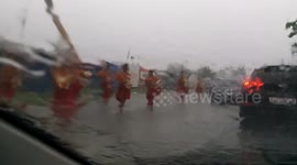 Philippine locals conduct religious march through ankle-deep floodwaters during severe typhoon
