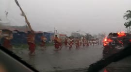 Philippine locals conduct religious march through ankle-deep floodwaters during severe typhoon