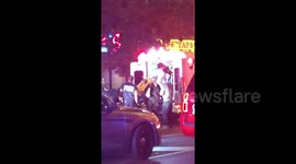 Crews help victims onto ambulance following Toronto shooting