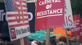 Protest Trump's Visit, Stop Trump, Protesters with signs march past building with Union Jack Flag. Portland Place, London, 13th July.