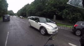 car head on with biker wrong side of road