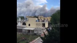 Holidaymakers watch smoke rise above Attica