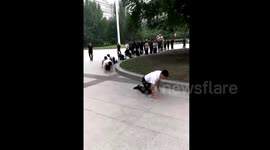 Chinese restaurant employees crawl on hands and knees as part of training