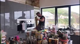 Builder air guitaring and karaoke singing whilst kitchen fitting to cope with the heat!