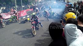 Moment biker's head nearly crushed in race pile-up