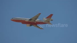DC-10 Air Tanker 910 firefighting plane flies over San Bernadino during wildfires