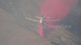 Wildfire: Air Tanker flies through smoke to drop fire retardant