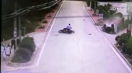Car falls into ditch and on its side after collision with bicycle