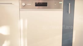 Housewife opens a dishwasher