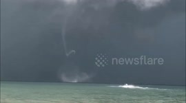 Rare twin waterspouts spotted spinning on beach on south China island