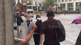 Londoners dash for cover as rain finally arrives