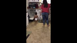 'Little helper' toddler assist his mummy with the dishes