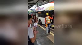 Kind-hearted builders shelter commuters with umbrellas during rain storm