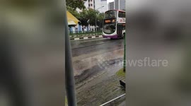 Kind-hearted builders shelter commuters with umbrellas during rain storm