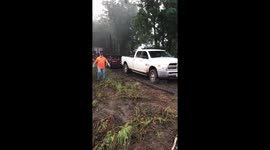 Dodge 4x4 pulling semi tractor trailer out of mud