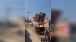 Demolition accident as building falls wrong way and crushes excavator