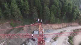Crazy tightrope walkers climbed a construction tower