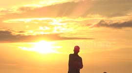silhouette of man holding baby during heatwave