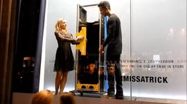 Troy the magician performs in shop window on London's Regent Street