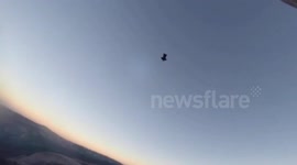 Climbers watch base jumpers from Yosemite rock face