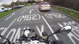 Car cuts up motorbike rider coming off roundabout