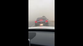 Cars navigate through wall of dust as large haboob slams Phoenix, Arizona