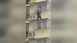 Hero cop rescues boy hanging from fifth-floor window