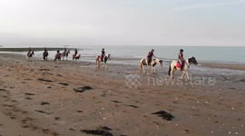 Pony riding on the Beach in Joss Bay Kent by jim connor young girls and boys riding there pony's on the beach in the sea with the white cliffs behind and the blue sea in front