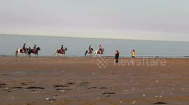 Pony riding on the Beach in Joss Bay Kent by jim connor young girls and boys riding there pony's on the beach in the sea with the white cliffs behind and the blue sea in front